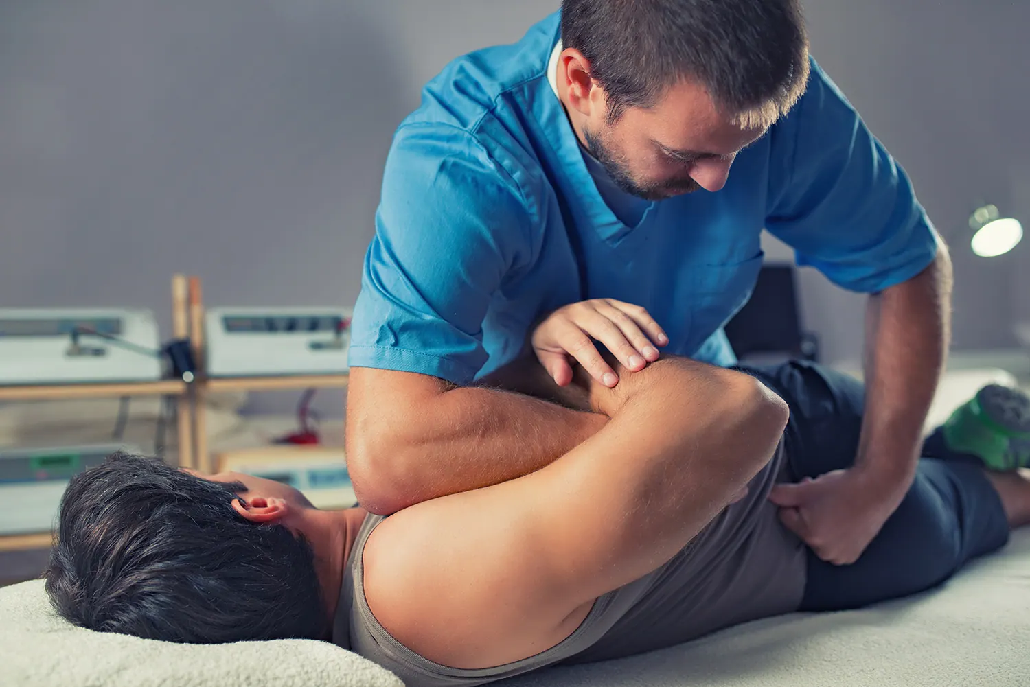 Chiropractor performing an adjustment on a patient