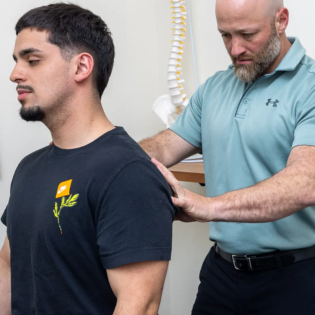 Dr. Eric Chludzinski doing a back pain treatment