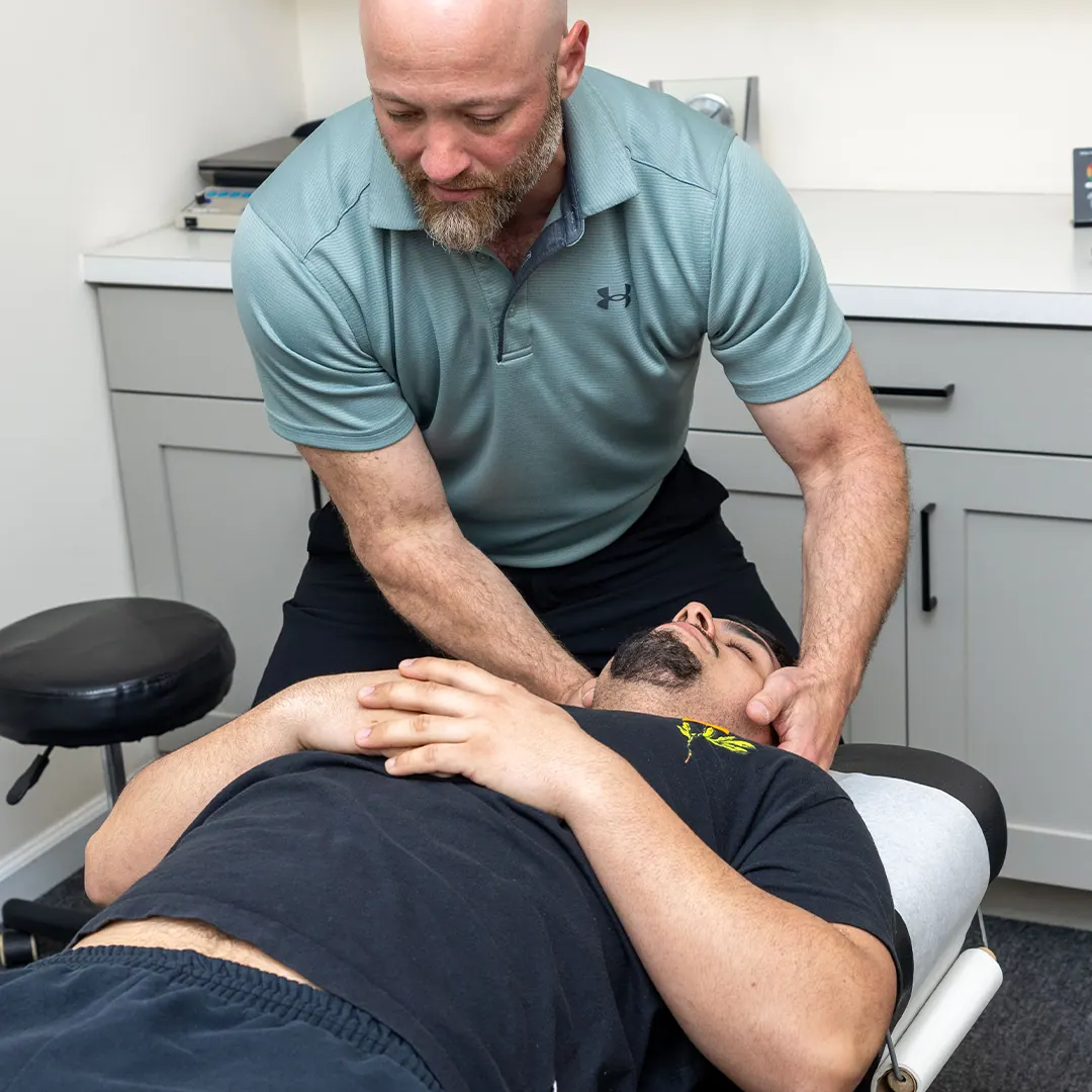Dr. Eric Chludzinski, neck pain treatment on patient