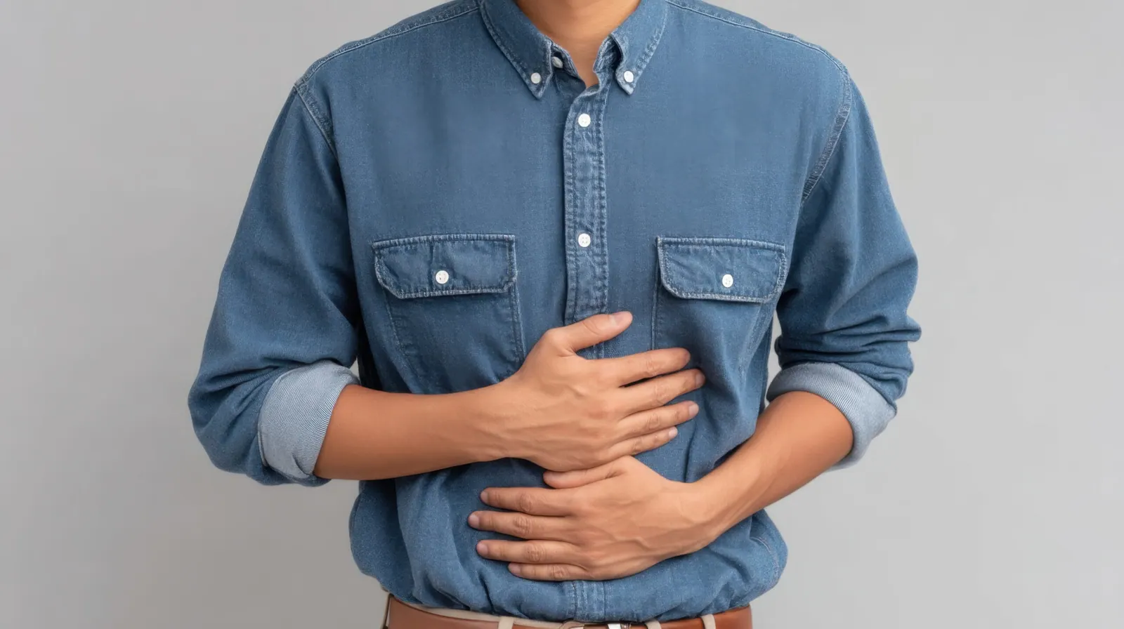 Man holding his upper stomach in discomfort