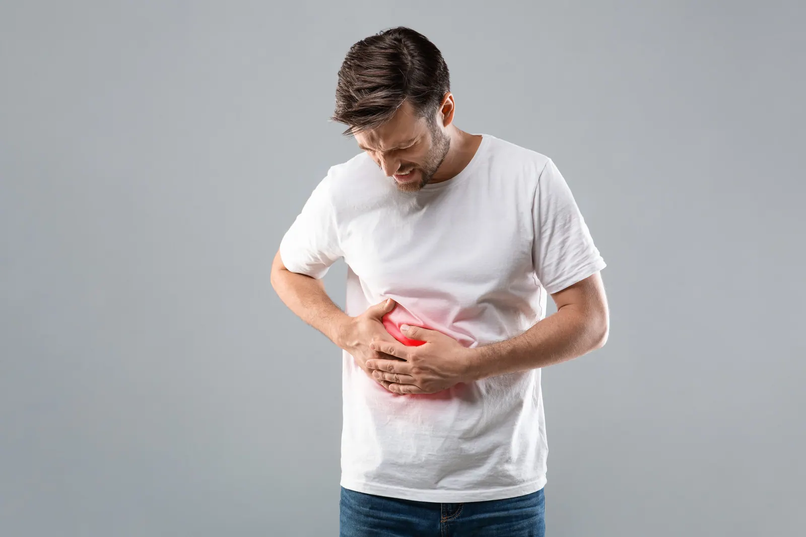 Man holding his side with abdominal pain