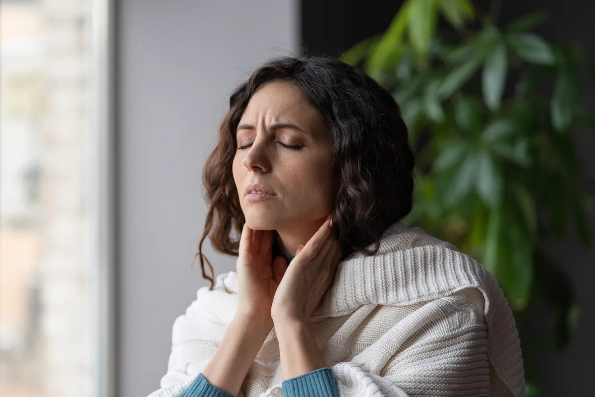 Woman holding her neck in pain