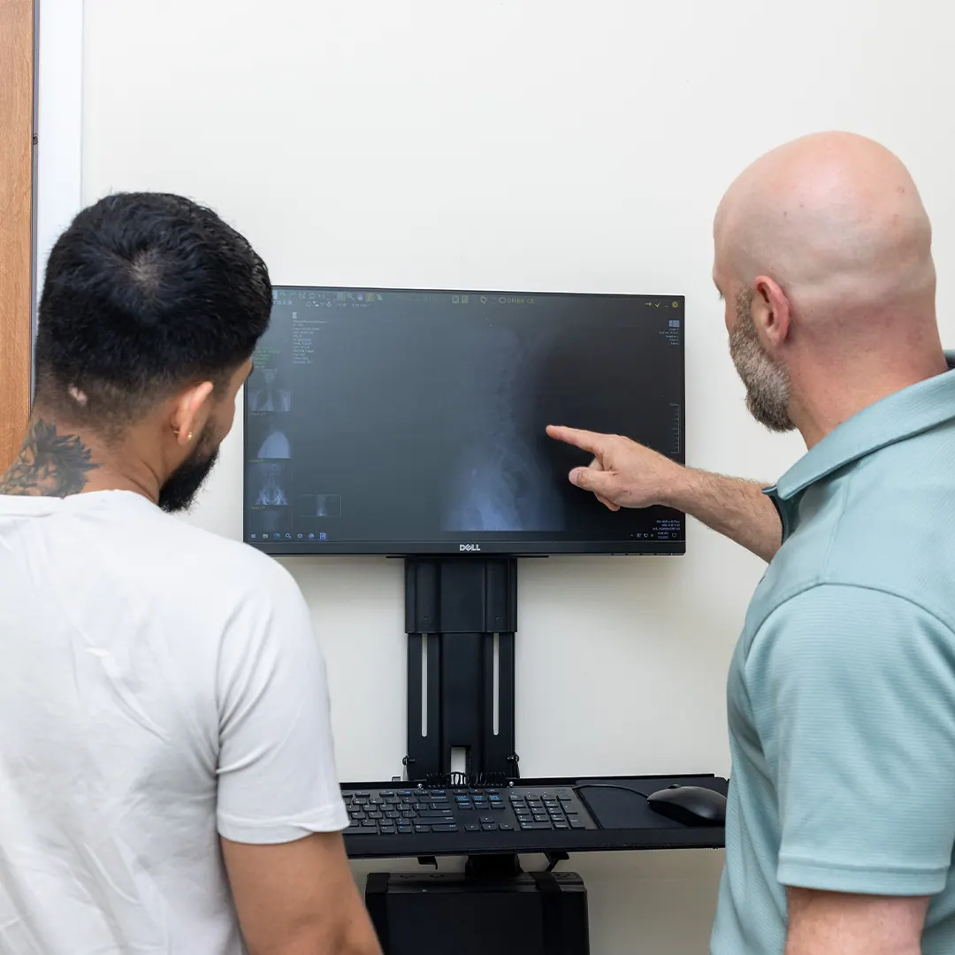 Dr. Eric Chludzinski showing patients xray